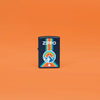 Lifestyle image of Zippo Logo Mountain Outdoor Logo Navy Matte Windproof Lighter standing in an orange scene.