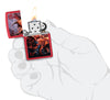 Zippo Anne Stokes Fire Dragon Design Red Matte Windproof Lighter lit in hand.