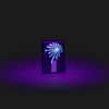 Lifestyle image of Zippo Black Light Lava Lamp Design Black Matte Windproof Lighter with the black light design glowing.