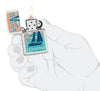 Zippo Buck Wear Nautical Design White Matte Windproof Lighter lit in hand.