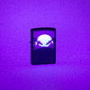 Lifestyle image of Sunset Black Light Design Black Lighter Black Matte Windproof Lighter showing the blacklight design.
